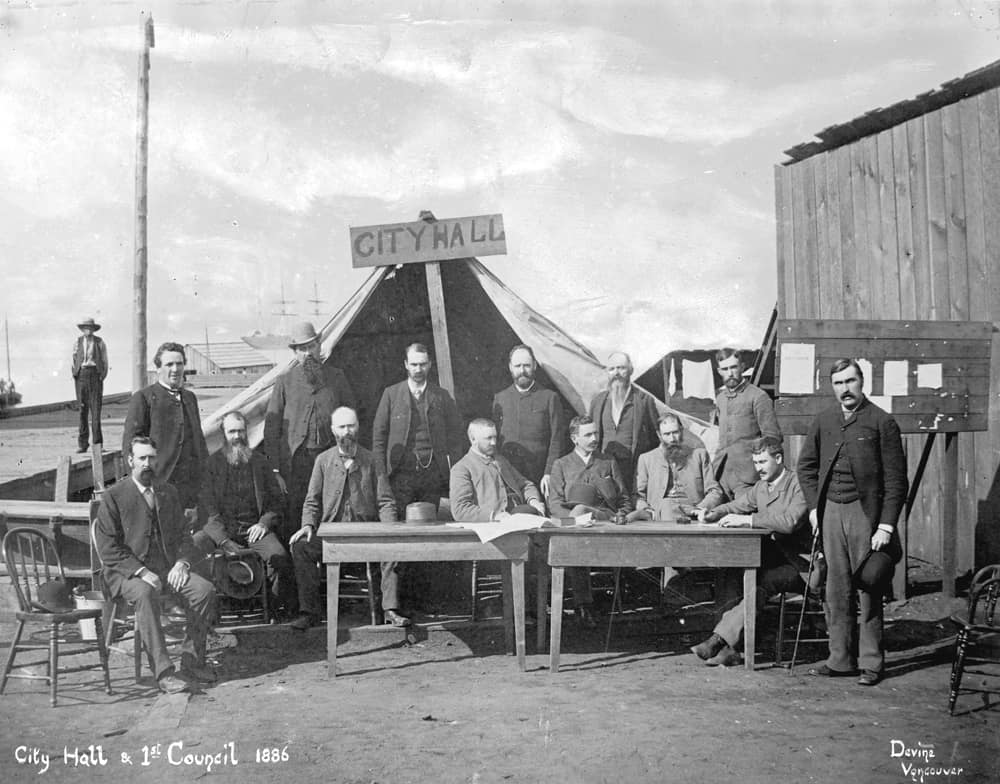 First City Hall meeting following the Great Fire of 1886. Mayor, Council and City officials assembled in front of a tent. City of Vancouver archives.